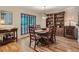 Elegant dining room with hardwood floors, wooden table set, built-in shelving, and natural light at 3265 W 11Th Avenue Ct, Broomfield, CO 80020