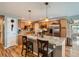 Well-lit kitchen featuring granite countertops, stainless steel appliances, hardwood floors, and center island at 3265 W 11Th Avenue Ct, Broomfield, CO 80020