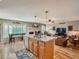 Spacious kitchen with central island, stainless steel appliances, hardwood flooring, and open layout to living area at 3265 W 11Th Avenue Ct, Broomfield, CO 80020