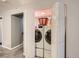 Laundry room with stacked washer and dryer tucked behind bifold doors at 3265 W 11Th Avenue Ct, Broomfield, CO 80020