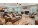 Warm living room featuring hardwood floors, fireplace, comfortable leather sofa, and access to the kitchen at 3265 W 11Th Avenue Ct, Broomfield, CO 80020