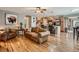 Open concept living room and kitchen area with hardwood floors, stainless appliances, and ample seating at 3265 W 11Th Avenue Ct, Broomfield, CO 80020
