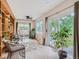 Bright sunroom with sliding doors, ceiling fan, wicker furniture, and built-in shelving at 3265 W 11Th Avenue Ct, Broomfield, CO 80020