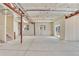 Unfinished basement with concrete floor, exposed ceiling and support beams, and natural light at 9002 Birch Run Dr, Parker, CO 80134