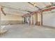 Unfinished basement with concrete flooring, exposed ductwork, and stairs leading up to the first floor at 9002 Birch Run Dr, Parker, CO 80134