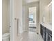 Bright bathroom featuring tiled shower, toilet, vanity, and views to a bedroom at 9002 Birch Run Dr, Parker, CO 80134