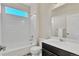 Bright bathroom featuring a tub with white tiles and a sleek single sink vanity at 9002 Birch Run Dr, Parker, CO 80134