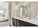 Bathroom features a double vanity with contemporary fixtures and views to a glass shower at 9002 Birch Run Dr, Parker, CO 80134