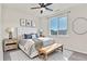 Well-lit bedroom featuring a tufted headboard, bench, and ample natural light at 9002 Birch Run Dr, Parker, CO 80134