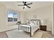 Cozy bedroom with a metal frame bed, window seat, and neutral decor at 9002 Birch Run Dr, Parker, CO 80134
