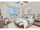 Comfortable bedroom with a cozy armchair, a large window, and warm lighting at 9002 Birch Run Dr, Parker, CO 80134