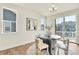 Bright dining area featuring a round table, modern chairs, and sliding glass doors at 9002 Birch Run Dr, Parker, CO 80134