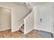 Entryway with carpeted stairs, white walls, wood flooring, and a blue patterned rug at 9002 Birch Run Dr, Parker, CO 80134