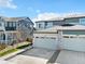 Charming townhome showcasing a spacious two-car garage, stone accents and a well-manicured front yard at 9002 Birch Run Dr, Parker, CO 80134