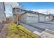 Inviting exterior of a modern townhome featuring a two-car garage and well-maintained landscaping at 9002 Birch Run Dr, Parker, CO 80134