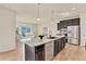 Spacious kitchen with a large island, stainless steel appliances, and an open view to the living area at 9002 Birch Run Dr, Parker, CO 80134