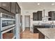 Contemporary kitchen with stainless steel appliances, dark cabinetry, and a functional layout for cooking at 9002 Birch Run Dr, Parker, CO 80134