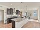 Modern kitchen with a center island, dark cabinetry, granite countertops, and stainless steel appliances at 9002 Birch Run Dr, Parker, CO 80134