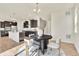 Open concept kitchen with a center island and dark cabinets adjoins a dining area with modern decor at 9002 Birch Run Dr, Parker, CO 80134