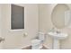Neat powder room features a pedestal sink, toilet, and window with blinds, and hardwood floors at 9002 Birch Run Dr, Parker, CO 80134