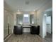 Bathroom with double vanity, large mirrors, and a walk-in shower at 544 Twilight St, Erie, CO 80516