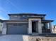 Two-story house with gray siding, stone accents, and a two-car garage at 544 Twilight St, Erie, CO 80516