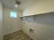 Laundry room with built-in shelving and tile flooring at 544 Twilight St, Erie, CO 80516