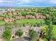 Scenic aerial view of townhomes nestled around a tranquil lake with lush green surroundings at 12658 W 1St Pl # 78, Denver, CO 80228