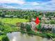Picturesque aerial view of a lakefront townhome with a spacious deck and lush landscaping at 12658 W 1St Pl # 78, Denver, CO 80228