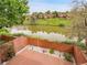 Backyard brick patio with lake view and a well-maintained fence for added privacy at 12658 W 1St Pl # 78, Denver, CO 80228