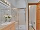 Bathroom featuring walk-in shower with a glass door and vanity at 12658 W 1St Pl # 78, Denver, CO 80228