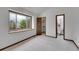Bedroom with neutral carpet, view to the outside, with attached closet and bathroom at 12658 W 1St Pl # 78, Denver, CO 80228