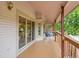 Covered deck with brown wood flooring and white siding offers a view of a lush, green landscape at 12658 W 1St Pl # 78, Denver, CO 80228