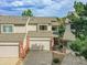 View of townhome front exterior with brick accents and a two-car garage at 12658 W 1St Pl # 78, Denver, CO 80228