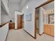 Bright hallway with a nook featuring wood cabinets and a view into a bathroom and large storage space at 12658 W 1St Pl # 78, Denver, CO 80228