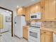 Bright kitchen features stainless steel appliances and light wood cabinetry at 12658 W 1St Pl # 78, Denver, CO 80228