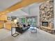 Bright living room with vaulted ceilings, a stone fireplace, and access to the deck at 12658 W 1St Pl # 78, Denver, CO 80228
