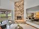 Inviting living room with a stone fireplace and sliding door access to the deck at 12658 W 1St Pl # 78, Denver, CO 80228