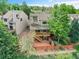 Aerial view of the rear of the house with a wooden deck and patio surrounded by a charming fenced yard at 12658 W 1St Pl # 78, Denver, CO 80228
