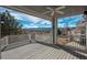 Expansive back deck with picturesque mountain views, sturdy railings, and ample space for outdoor entertaining and relaxation at 2472 W Peakview Ct, Littleton, CO 80120