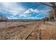 Large open backyard with scenic mountain views, and a white picket fence at 2472 W Peakview Ct, Littleton, CO 80120
