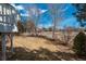 Landscaped backyard with a well-maintained lawn, fence and mature trees at 2472 W Peakview Ct, Littleton, CO 80120