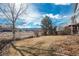 Backyard featuring well-maintained lawn, partial fence, and mature trees at 2472 W Peakview Ct, Littleton, CO 80120