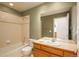 Bright bathroom featuring a tub with shower, toilet, and a vanity with a sink, providing necessary amenities at 2472 W Peakview Ct, Littleton, CO 80120