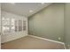 This carpeted bedroom features a neutral color palette and bright, natural light through the window at 2472 W Peakview Ct, Littleton, CO 80120