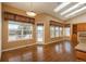 Open-concept dining area featuring hardwood floors, a pendant light, large windows with scenic views, and plenty of natural light at 2472 W Peakview Ct, Littleton, CO 80120
