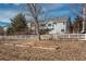 Charming grey home with a white picket fence and landscaped garden beds at 2472 W Peakview Ct, Littleton, CO 80120