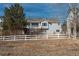 Charming grey home with a white picket fence and balcony at 2472 W Peakview Ct, Littleton, CO 80120