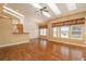 Open-concept living room with hardwood floors, a cozy fireplace, vaulted ceilings and great natural light from several windows at 2472 W Peakview Ct, Littleton, CO 80120