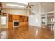 Spacious living room featuring hardwood floors, a fireplace, a built-in bookcase and an open layout with an attached room at 2472 W Peakview Ct, Littleton, CO 80120